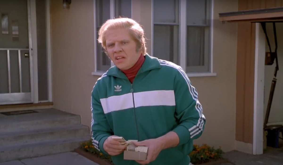 Back To The Future Part II Biff standing in his tracksuit, ready to pass out matchbooks