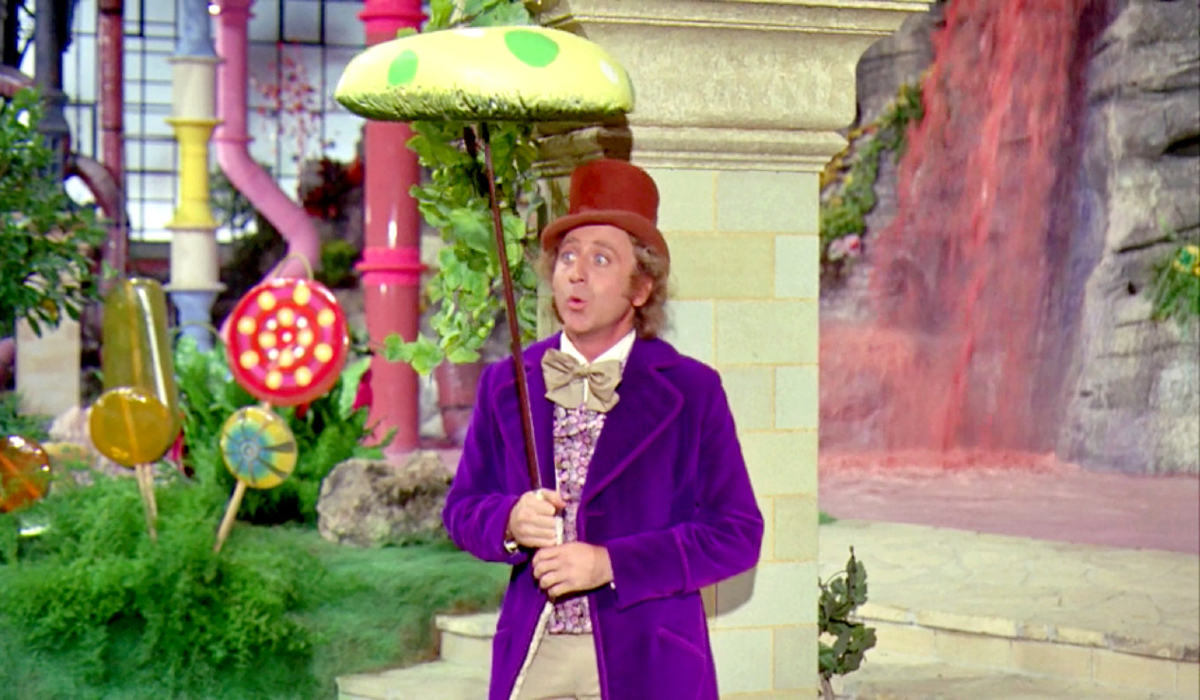 Willy Wonka & the Chocolate Factory Gene Wilder in costume, holding a candy mushroom