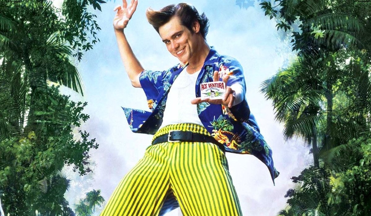 Ace Ventura: When Nature Calls Jim Carrey flashes his ID card among the trees
