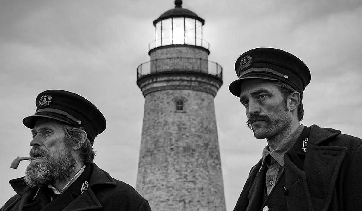 The Lighthouse behind Willem Dafoe and Robert Pattinson outside