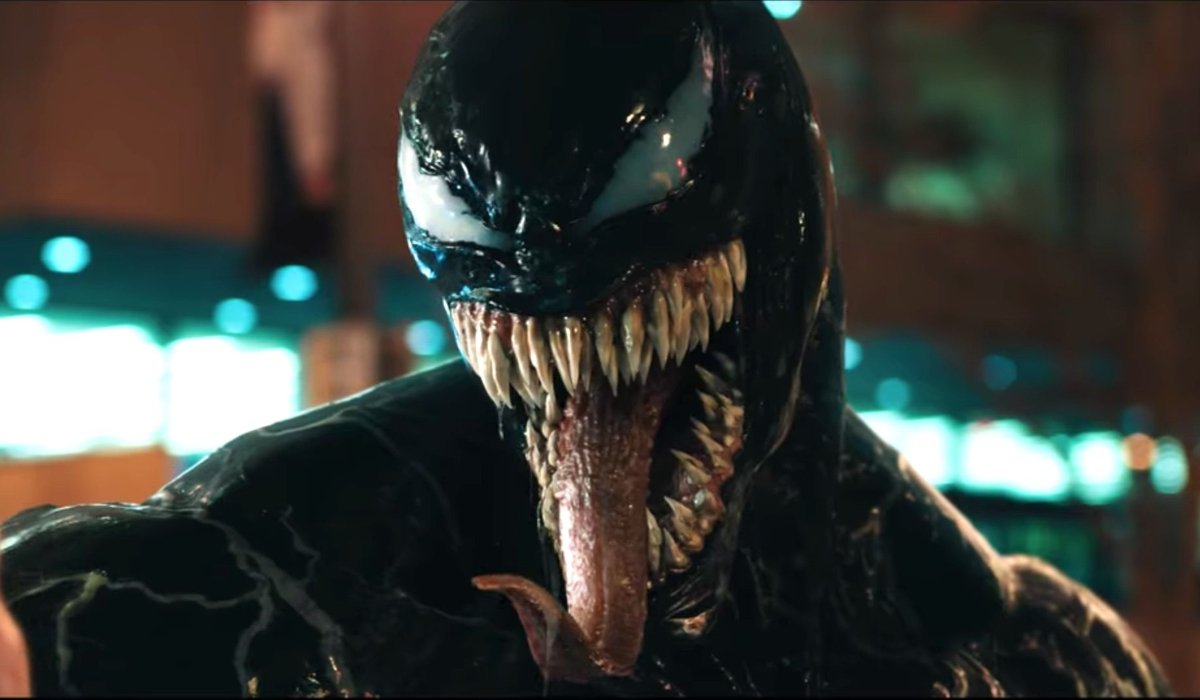 Venom with his tongue out, ready to eat a man's head off