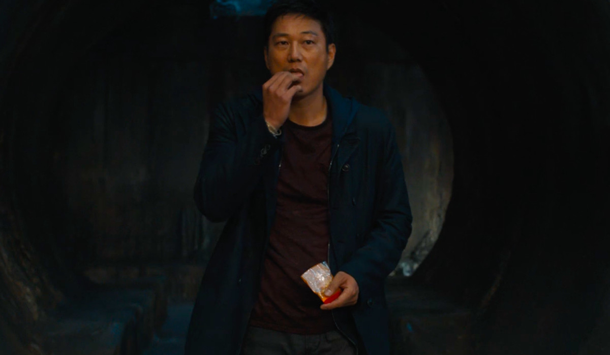 F9 Sung Kang emerges from a tunnel, eating