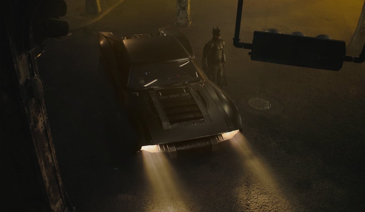 Robert Pattinson's Batman next to Batmobile