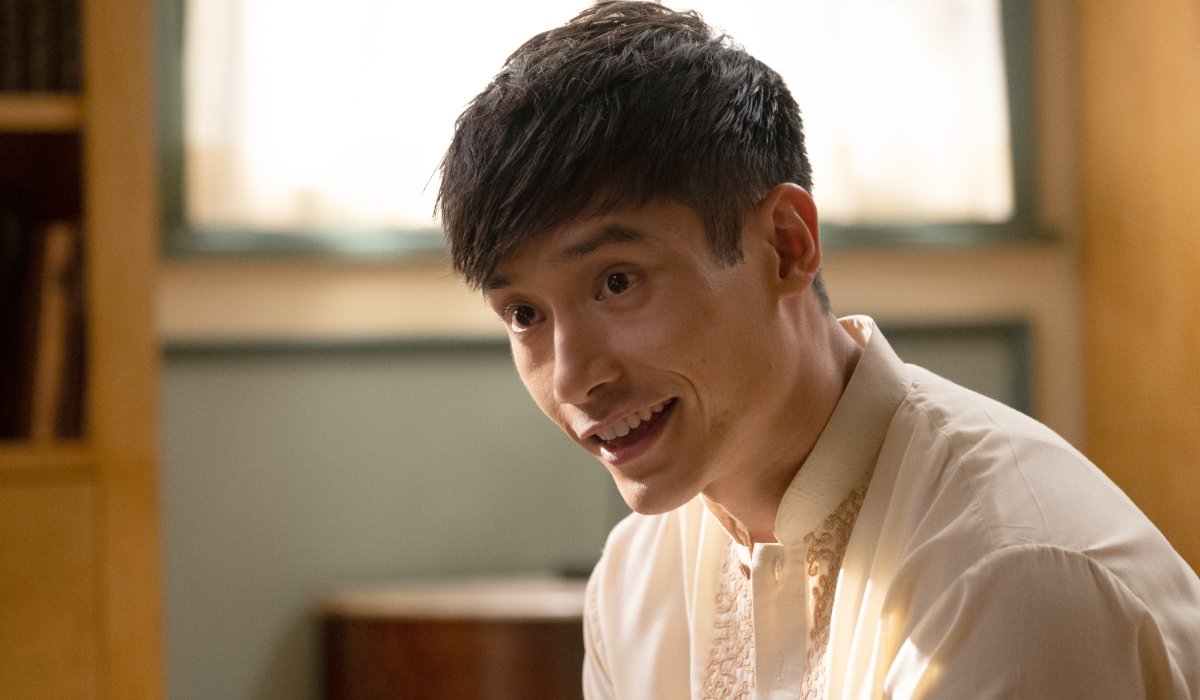 The Good Place Manny Jacinto sitting in a brightly lit room