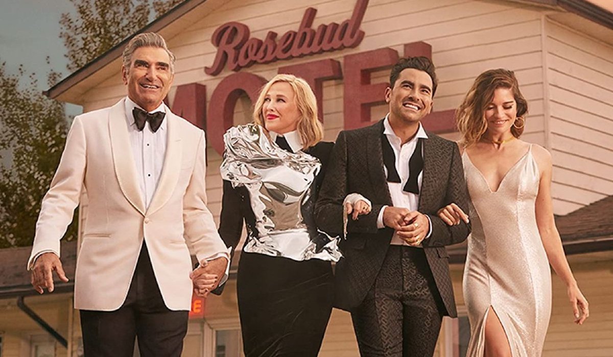 Schitt's Creek the Rose family dressed up in front of the motel
