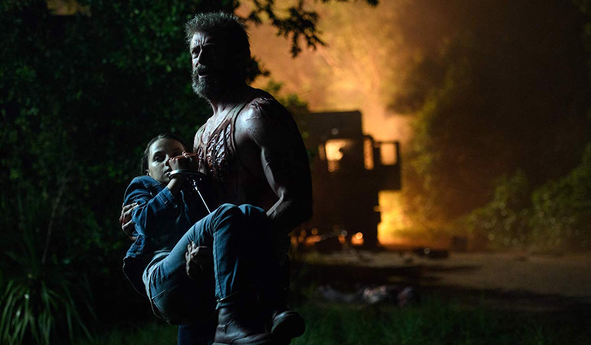Wolverine carrying Laura in Logan