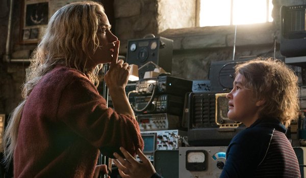A Quiet Place Emily Blunt signals Millicent Simmonds to be quiet in front of the radios