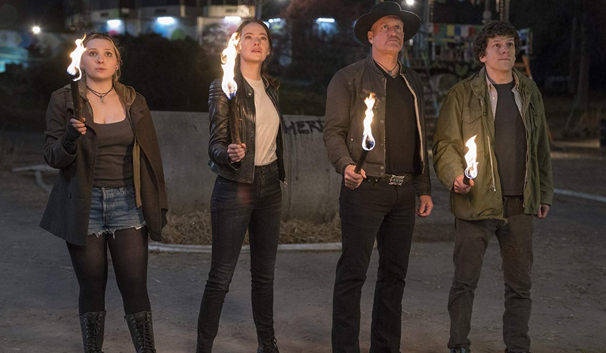 Zombieland: Double Tap the team holds torches in the dark
