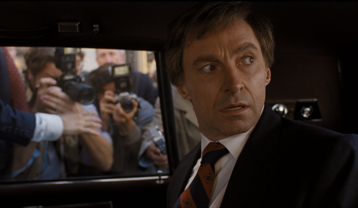 The Front Runner Hugh Jackman looks over his shoulder, in a limo surrounded by cameras