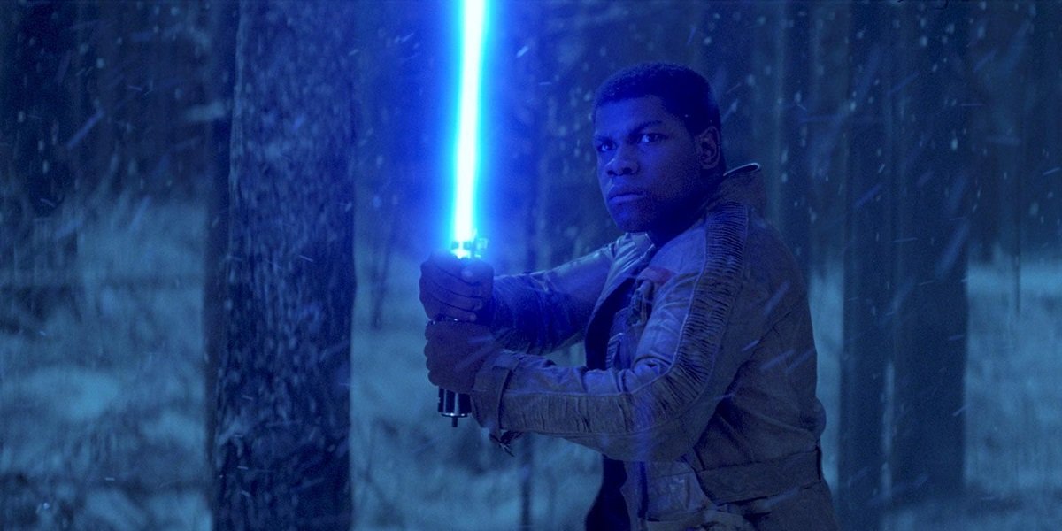 Finn with lightsaber in Star Wars: The Force Awakens