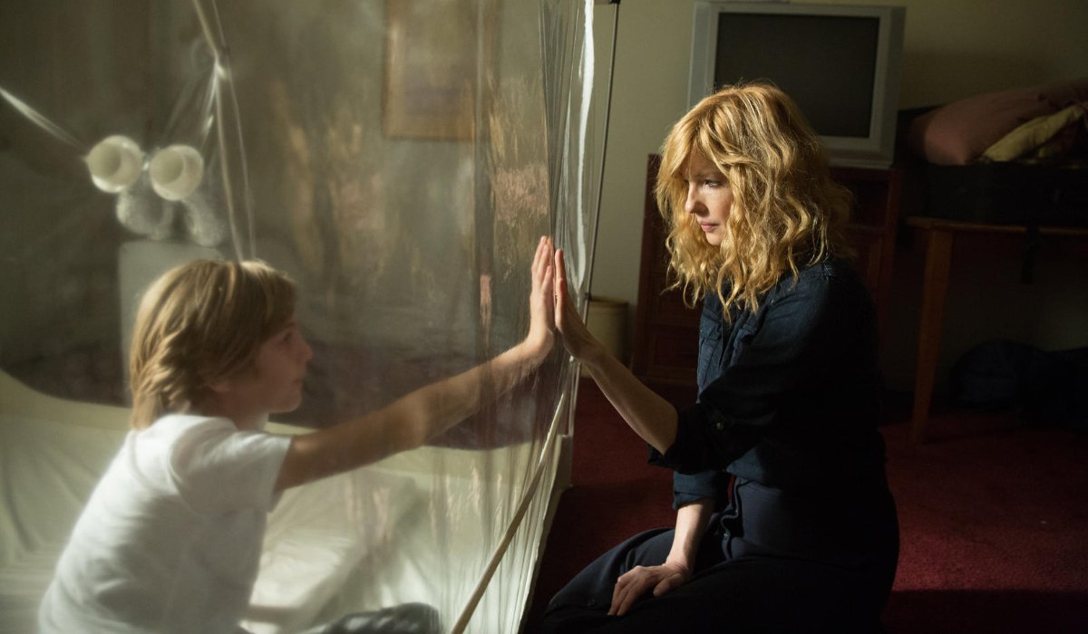 Eli Kelly Reilly looks at her son through a plastic bubble