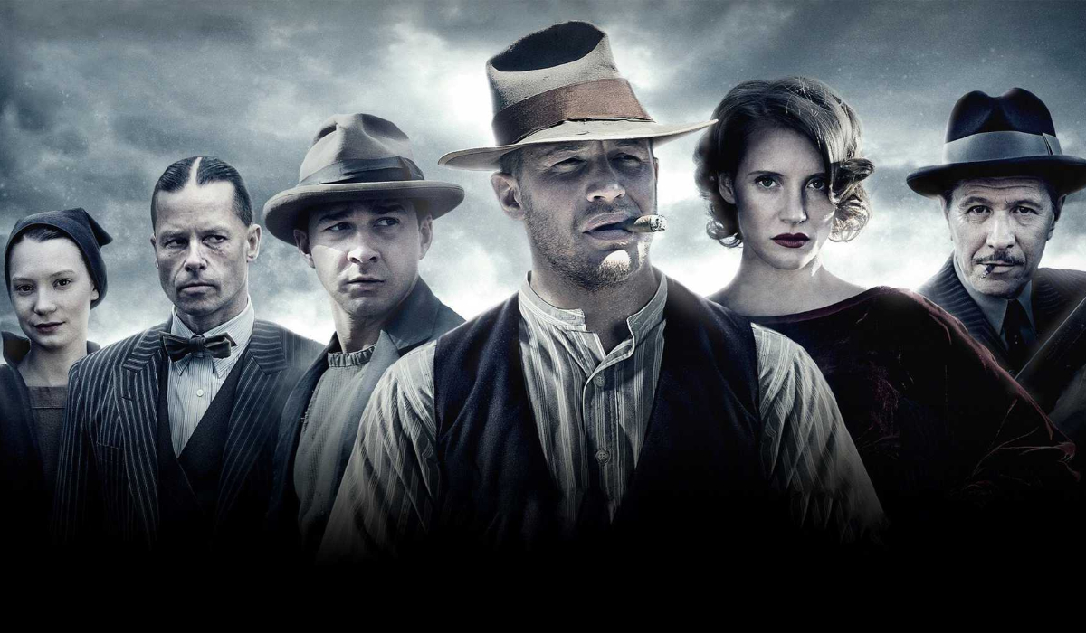 Lawless cast lined up in front of a cloudy background