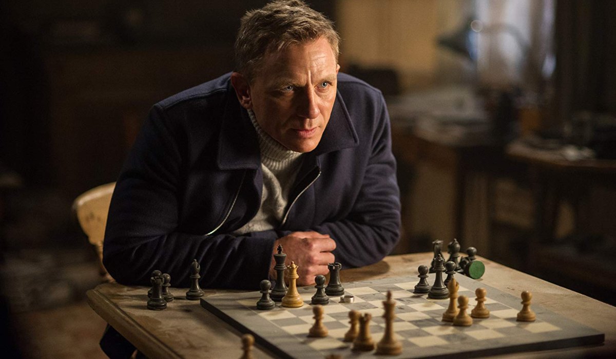 Spectre James Bond perched over chess board