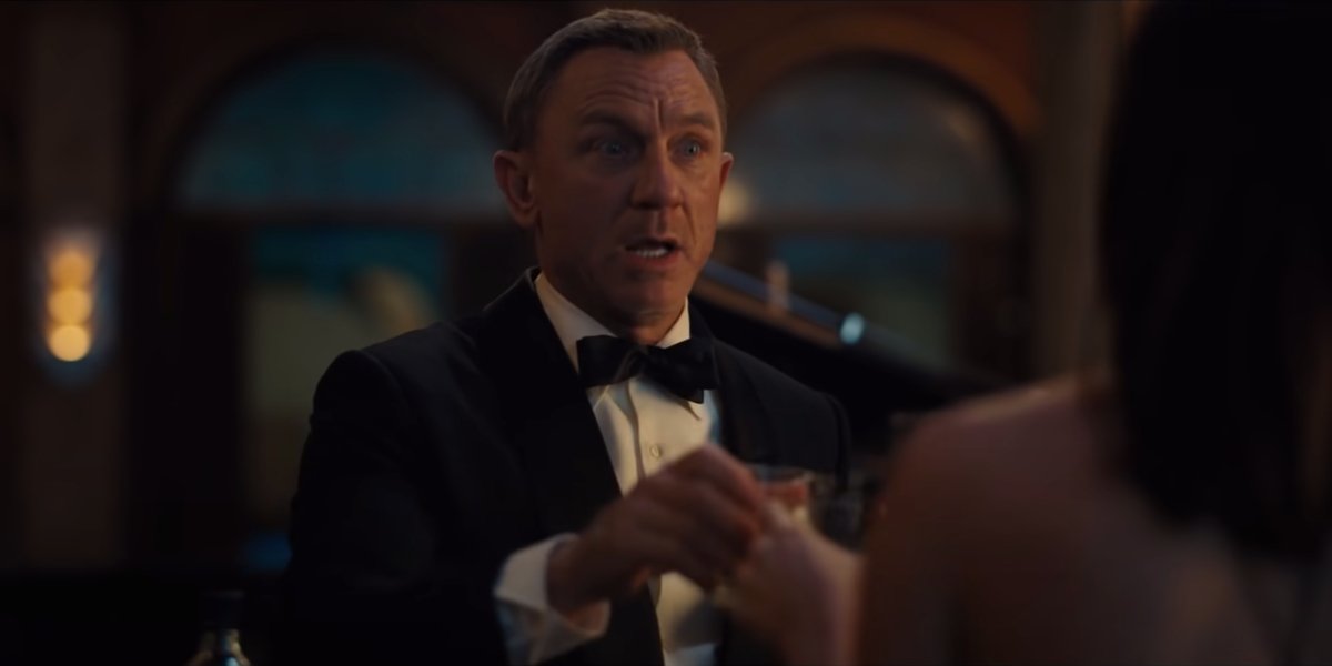 Daniel Craig makes an anxious toast in No Time To Die.
